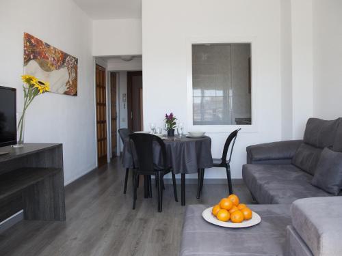 a living room with a table and a couch at Apartaments Atzavara in Calella