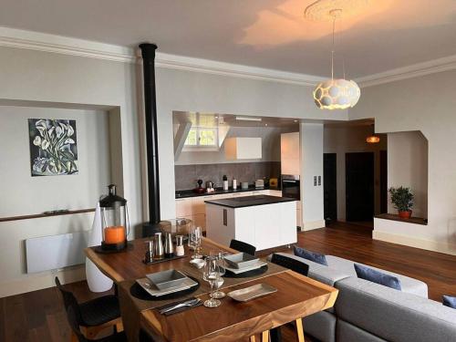 a living room with a table and a kitchen at Cabana & Nuit de Château au bord du Lac Léman in Lugrin
