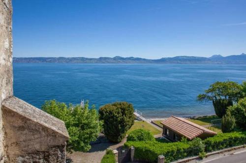 a view of the water from a building at Cabana & Nuit de Château au bord du Lac Léman in Lugrin