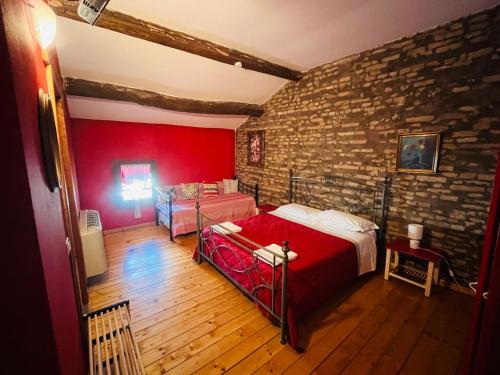 a bedroom with a bed and a brick wall at La Locanda degli Artisti in Medelana