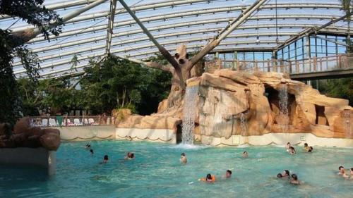 a group of people in a pool at a theme park at La Bohème in Paissy