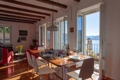a dining room with a table and chairs with a view at Cadebei in Oggebbio