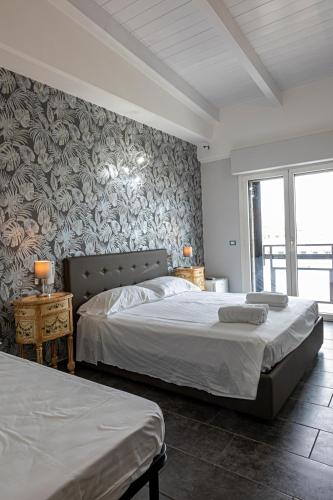 a bedroom with two beds and a wall mural at B&B Bellavista in Margherita di Savoia