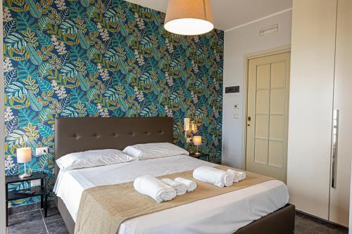 a bedroom with a large bed with towels on it at B&B Bellavista in Margherita di Savoia
