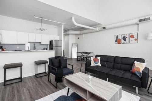 a living room with a couch and a table at 2BR 2BA In The Block Apartment by CozySuites in Indianapolis