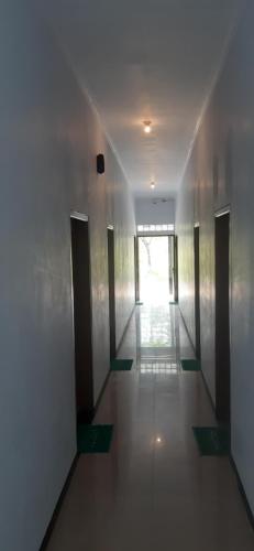 a hallway of a building with doors and a window at Lejo Grand Hotel in Cikembulan