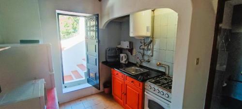a small kitchen with a stove and a sink at Quinta do Lagar - 10 in Albufeira