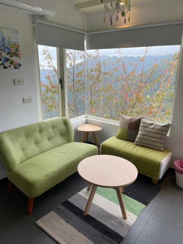 a living room with a couch and a table and a window at Gegbyan in Ch'ia-la