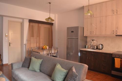 a living room with a couch and a kitchen at Not a Villa in Roussospítion