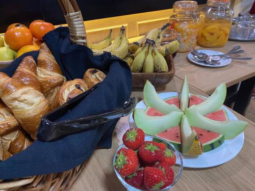 a table with a bunch of bread and fruit on it at Kings Arms Hotel in Lockerbie