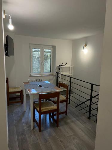 a dining room with a table and two chairs at Agriturismo Quartuccio in Oricola