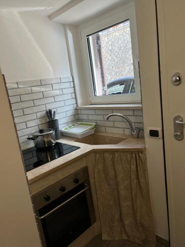 a small kitchen with a sink and a window at Agriturismo Quartuccio in Oricola