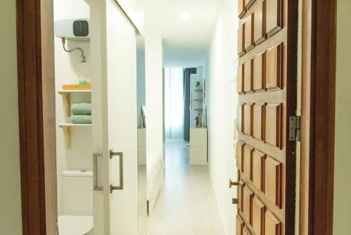 a hallway with a door leading to a bedroom at Lindamar Canteras Beach House in Las Palmas de Gran Canaria