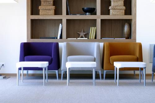 a room with three chairs and a table and shelves at Rota Suites in Sorrento