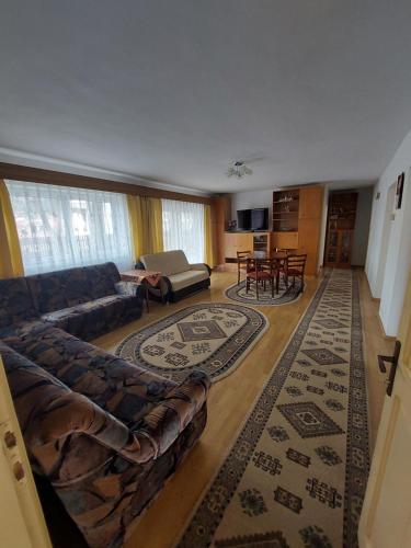 a living room with a couch and a table at Casa Kasandra in Buşteni