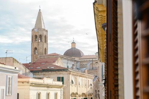 a view of a city with a clock tower at Emperador in Alghero