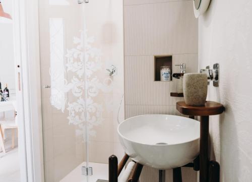 a bathroom with a white sink and a shower at Mare Adesso in Polignano a Mare