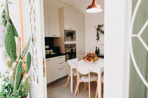 a kitchen with a white table and white chairs at Mare Adesso in Polignano a Mare