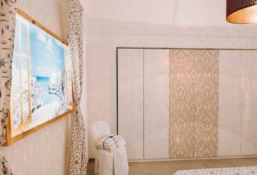 a dressing room with a cabinet and a window at Mare Adesso in Polignano a Mare