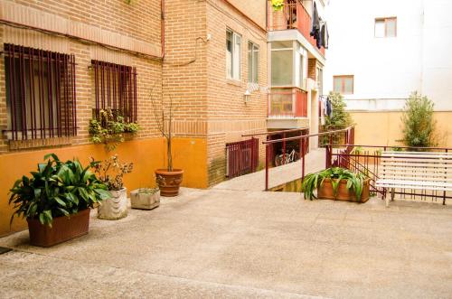 a balcony with potted plants and a brick building at Habitacion en Centro de Las Rozas de Madrid in Las Rozas de Madrid