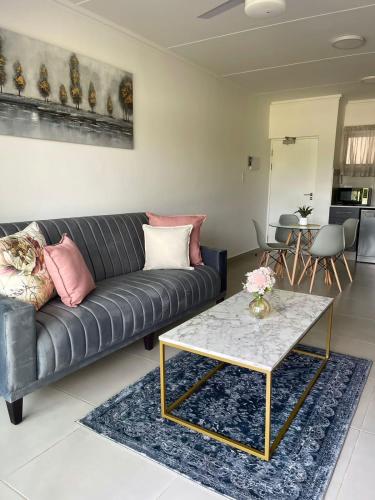 a living room with a couch and a table at 151 Ballito Luxury Villa in Ballito