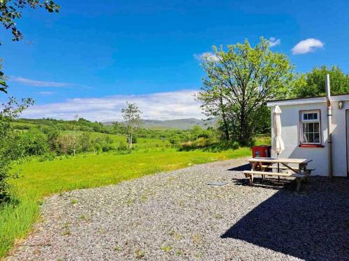 a picnic table in front of a white building at Eanymore Farm Cottage in Donegal