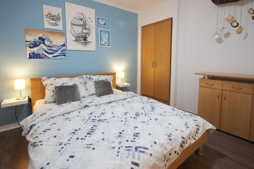 a bedroom with a large bed with blue walls at Apartment Blue in Poreč