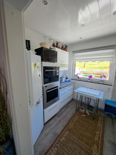 a kitchen with a white refrigerator and a table at Ferienwohnung Galina 1 in Rockenhausen