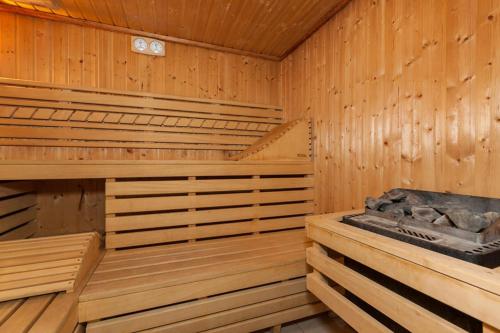 a wooden sauna with a tub in it at Kamienica Parkowa in Dąbki