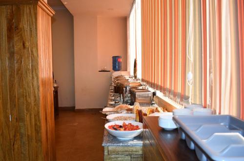 a long counter with bowls of food on it at Hotel Fewa Camp in Pokhara