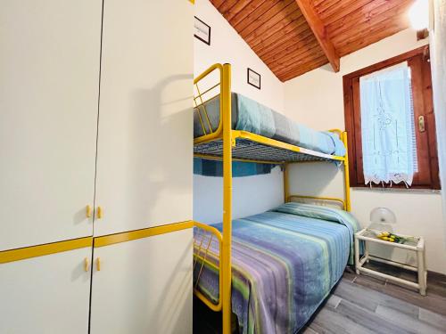 a bedroom with two bunk beds in a house at -EXCLUSIVE PRIVATE VILLA- Villasimius in Villasimius
