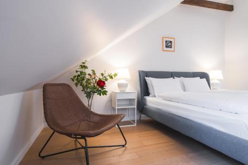 um quarto com uma cama e uma cadeira em Lollo Residence - Lollo Luxury em Vilnius