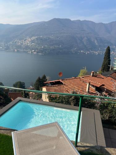 a swimming pool with a view of a body of water at VILLA Como, Jacuzzi Spa and Private Pool in Blevio
