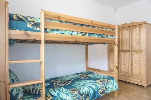a bedroom with two bunk beds and a closet at Apartament Cisza in Rabka