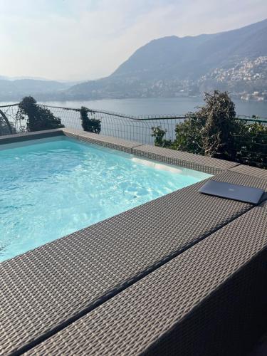 a swimming pool with a laptop sitting on top of it at VILLA Como, Jacuzzi Spa and Private Pool in Blevio
