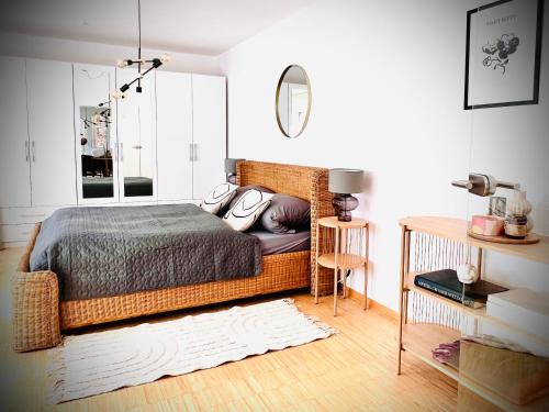 a bedroom with a bed and a mirror at Das Stader Refugium in Stade