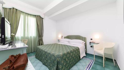 Postel nebo postele na pokoji v ubytování Hotel Santa Caterina