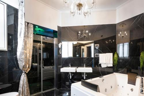 a bathroom with a tub and a sink and a mirror at Hotel Relais Dei Papi in Rome