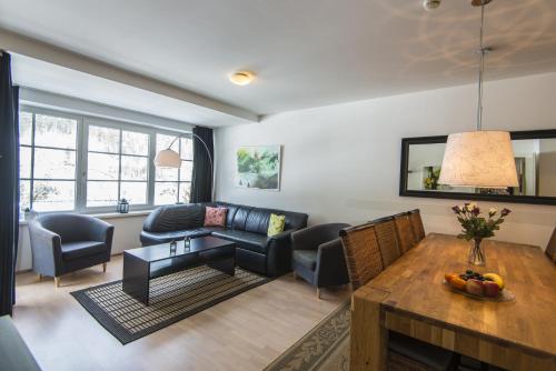a living room with a couch and a table at Sonnenwende by AlpenTravel in Bad Gastein
