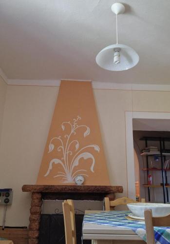 a dining room table with a wall with a painting on it at Casetta della chiocciola in Sassi