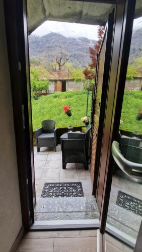 an open door to a patio with a view of a yard at CASA BAT in Mantello