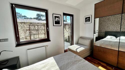 a bedroom with a bed and a window at Aqua Villa 4 in Jurata