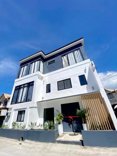 a white building with a lot of windows at NEW Modern home near Airport, Beach and Fast Wi-Fi in Sudtungan