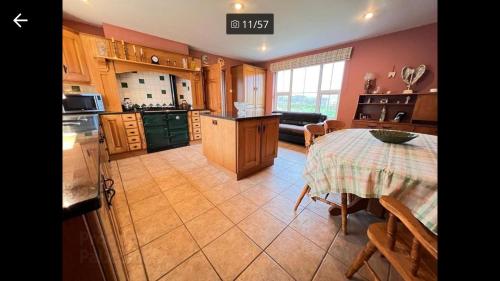 a kitchen with a table and a kitchen with a tableablish at Asdee House in Bushmills