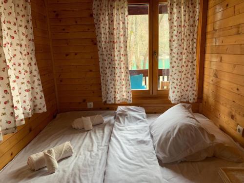 a room with two beds in a log cabin at Drinka in Ljubovija