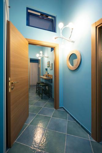 a hallway with a door and a room with a table at Casina Lambis in Pozzuoli