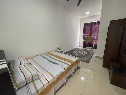 a small bedroom with a bed and a window at Safiyya Homestay in Kluang