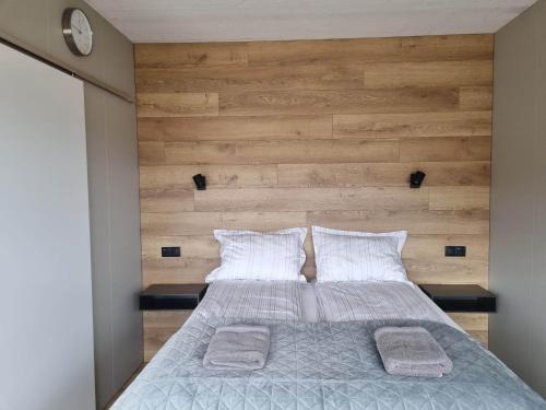 a bedroom with a large bed with two pillows at New and well furnished studio apartment for two 30 km from Kirkjubæjarklaustur Perfect place to stay at right between Black beach and Jökulsárlón in Kirkjubæjarklaustur
