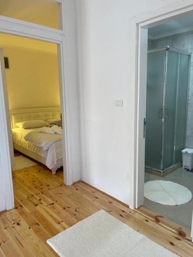 a bedroom with a bed and a glass door at Apartment Soreja in Ulcinj