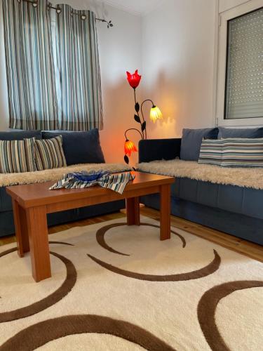 a living room with two couches and a coffee table at Apartment Soreja in Ulcinj